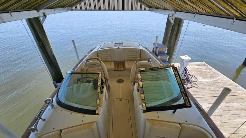 Slide: The Image of 2013 Chris-Craft Launch 22 boat docked under a canopy, viewed from above. - 14