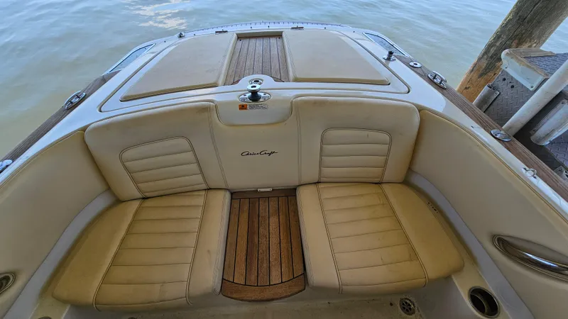 Slide: The Image of 2013 Chris-Craft Launch 22 boat interior with beige seating and wooden accents. - 16