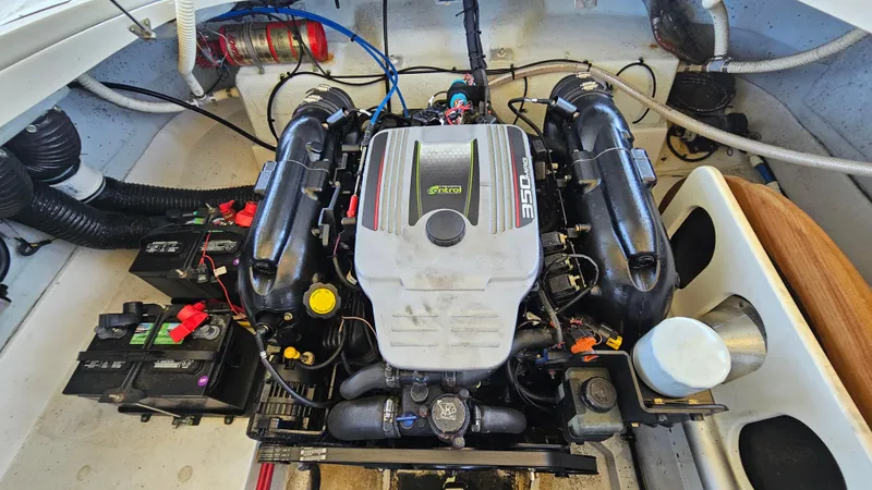 Slide: The Image of Engine compartment of a 2013 Chris-Craft Launch 22 boat, featuring a powerful engine setup. - 18