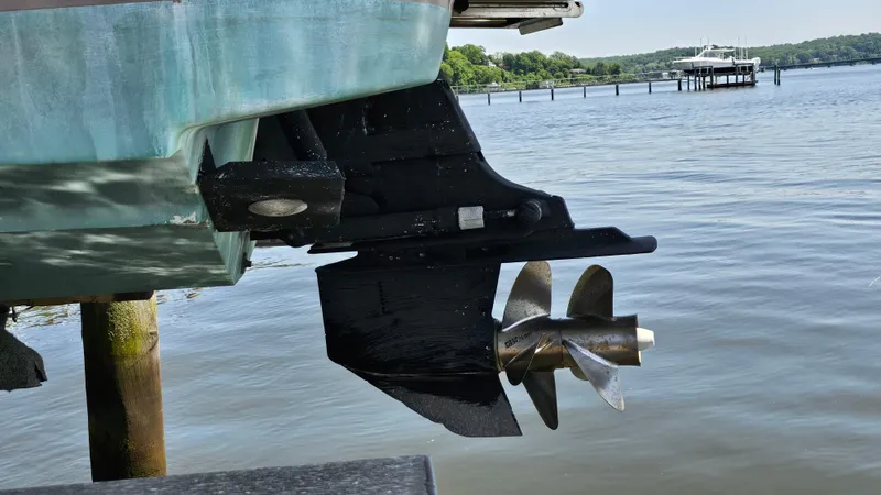 Slide: The Image of Chris-Craft Launch 22 boat propeller and stern, docked by a serene lake. - 21