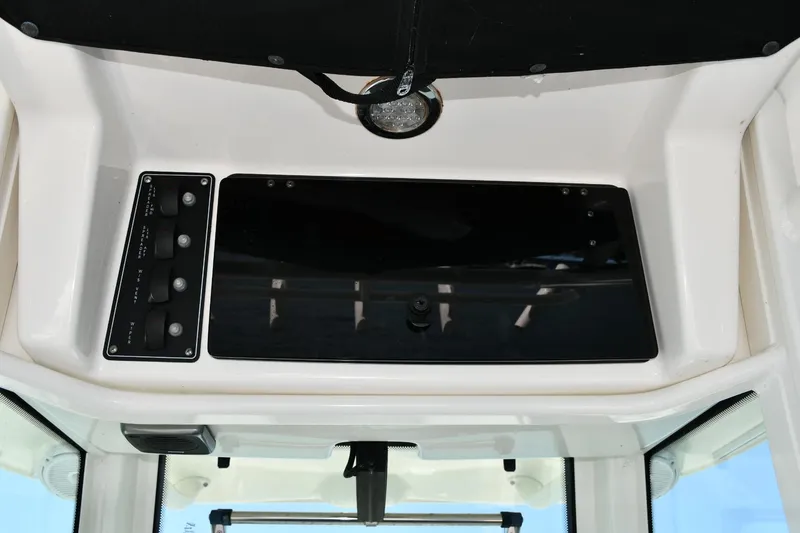 Slide: The Image of Control panel of a 2016 Boston Whaler 280 Outrage boat with steering wheel and navigation equipment. - 10