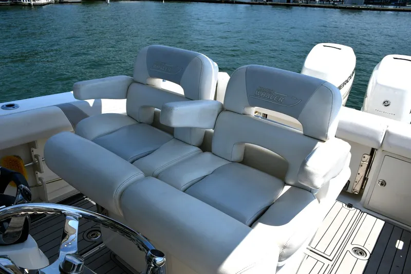 Slide: The Image of 2016 Boston Whaler 280 Outrage boat interior with plush seating and steering wheel. - 16