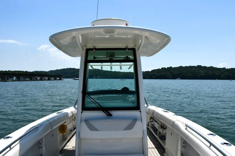 Slide: The Image of 2016 Boston Whaler 280 Outrage boat on water, showcasing helm and seating area. - 18