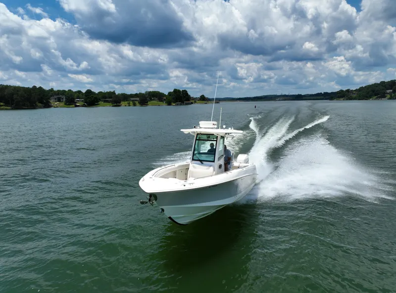 Slide: The Image of Boston Whaler 280 Outrage 2016 cruising on a lake under a clear blue sky. - 2