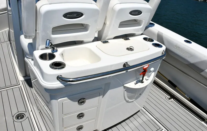 Slide: The Image of Boston Whaler 280 Outrage 2016 boat interior with white seating on a sunny day. - 20