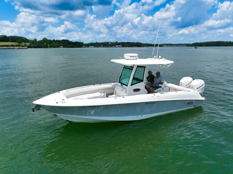 Slide: The Image of 2016 Boston Whaler 280 Outrage boat on water, featuring twin Mercury engines. - 4
