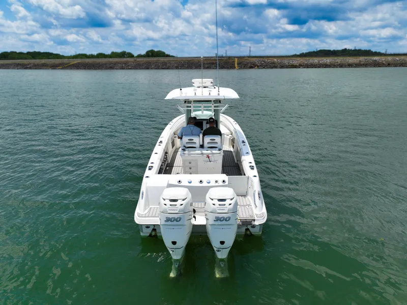 Slide: The Image of 2016 Boston Whaler 280 Outrage boat on calm water under a cloudy sky. - 5