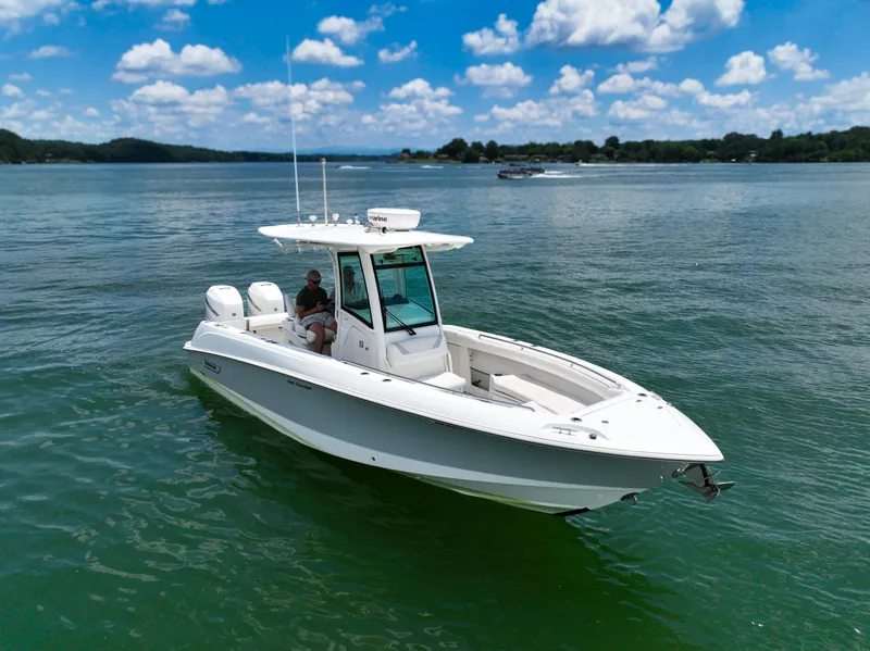 Slide: The Image of 2016 Boston Whaler 280 Outrage boat on calm water under a blue sky. - 6