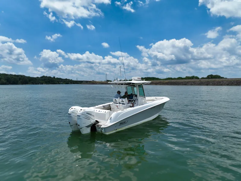 Slide: The Image of 2016 Boston Whaler 280 Outrage boat helm with steering wheel and navigation system. - 7