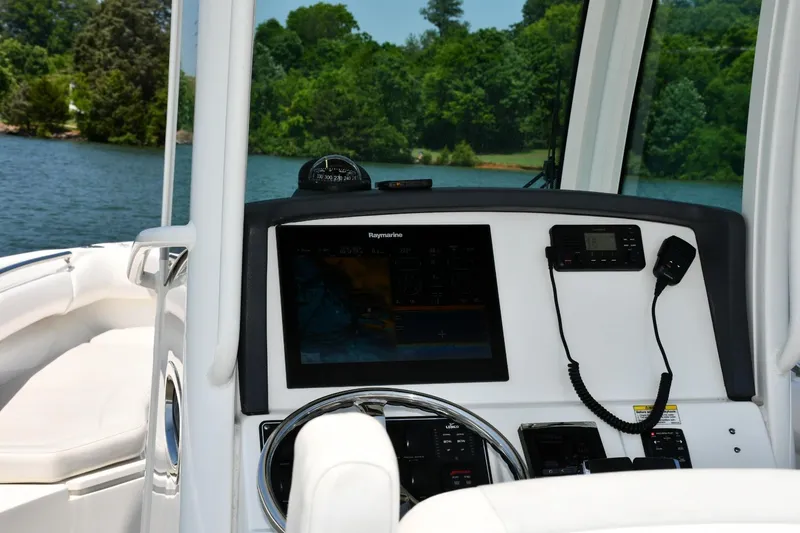 Slide: The Image of 2016 Boston Whaler 280 Outrage dashboard with control panel and storage compartment. - 9