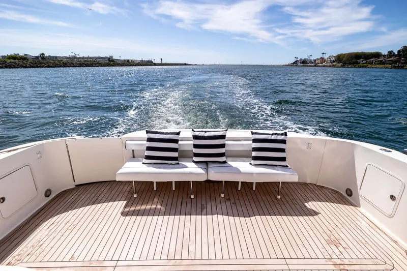 Slide: The Image of Rear view of 2002 Sea Ray 560 Sedan Bridge yacht with striped cushions on deck. - 19