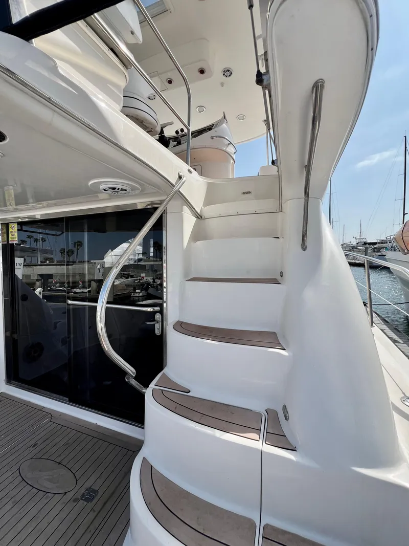 Slide: The Image of Staircase on 2002 Sea Ray 560 Sedan Bridge yacht, leading to upper deck. - 21