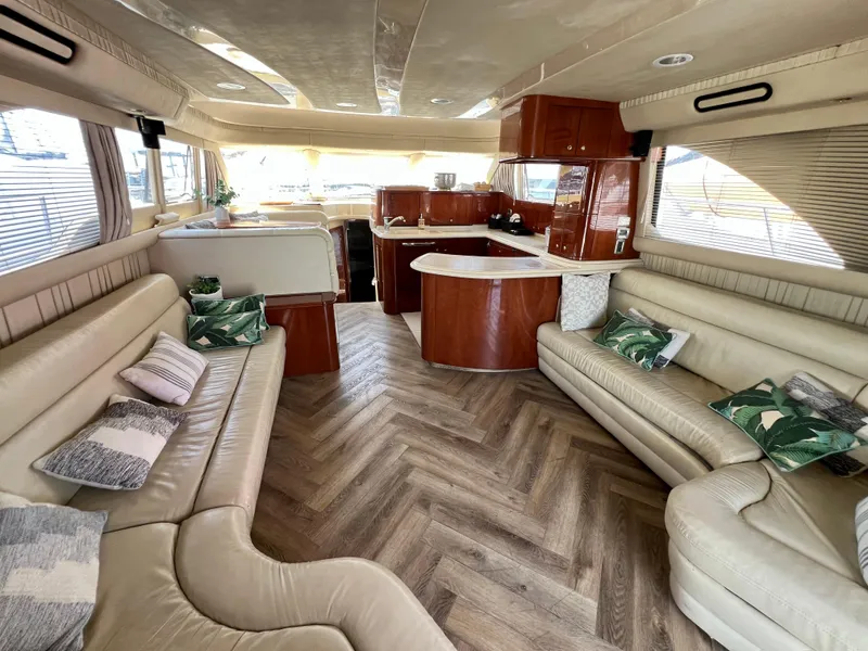 Slide: The Image of Luxurious interior of a 2002 Sea Ray 560 Sedan Bridge yacht with elegant seating and wood finishes. - 29