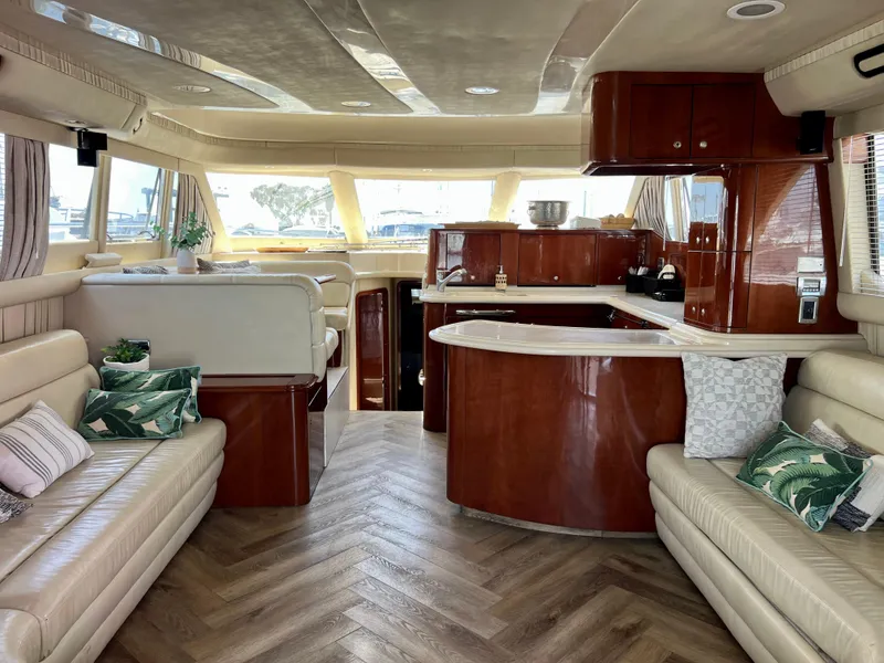 Slide: The Image of Luxurious interior of a 2002 Sea Ray 560 Sedan Bridge yacht with elegant wood finishes. - 30