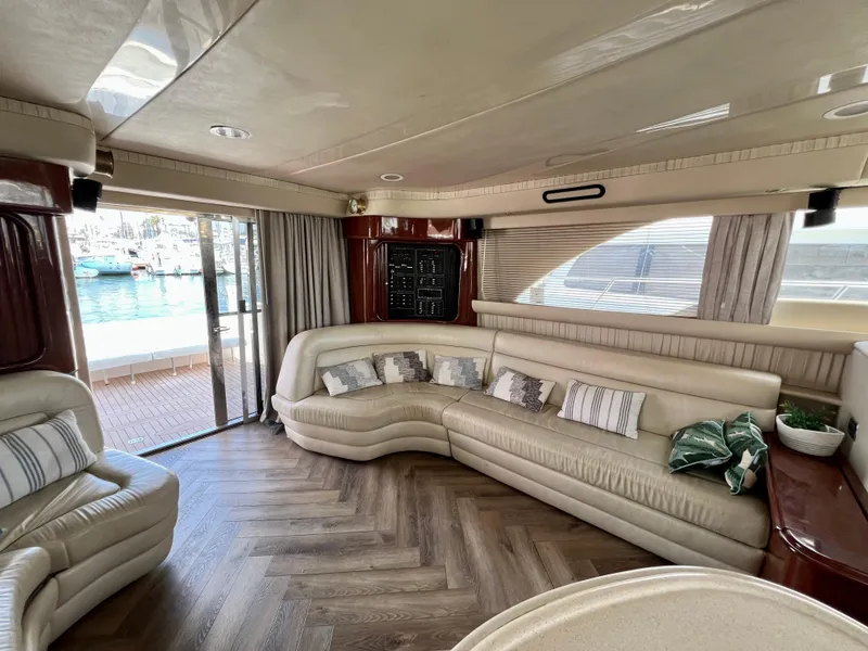 Slide: The Image of Luxurious interior of 2002 Sea Ray 560 Sedan Bridge yacht with plush seating and waterfront view. - 31