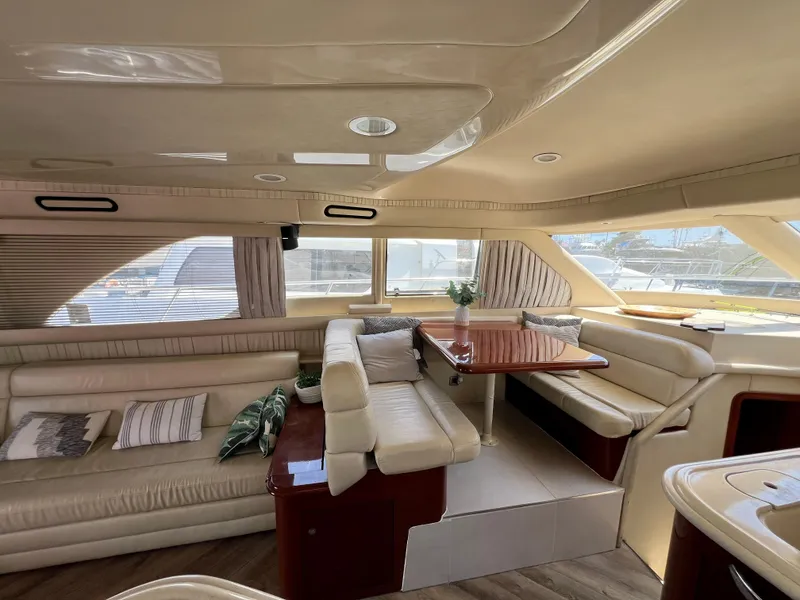 Slide: The Image of Luxurious interior of 2002 Sea Ray 560 Sedan Bridge yacht with elegant seating and dining area. - 33