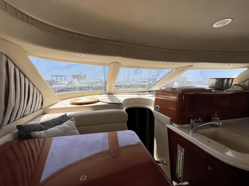 Slide: The Image of Interior of 2002 Sea Ray 560 Sedan Bridge yacht with kitchen and seating area. - 35