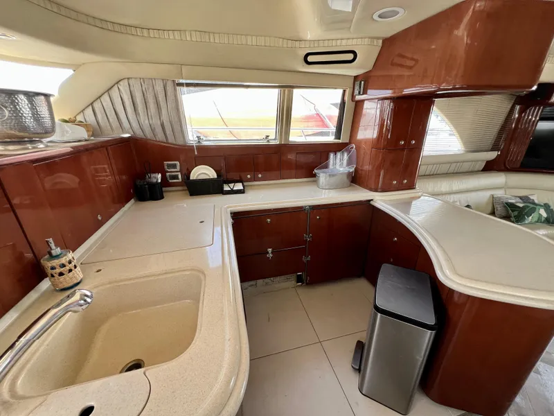 Slide: The Image of Luxurious kitchen interior of 2002 Sea Ray 560 Sedan Bridge yacht with wood cabinetry. - 37
