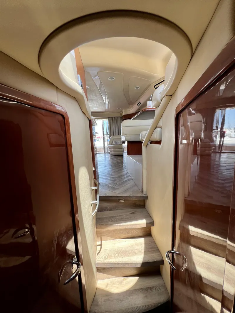 Slide: The Image of Interior view of 2002 Sea Ray 560 Sedan Bridge yacht, featuring elegant wooden stairs and luxurious seating. - 39
