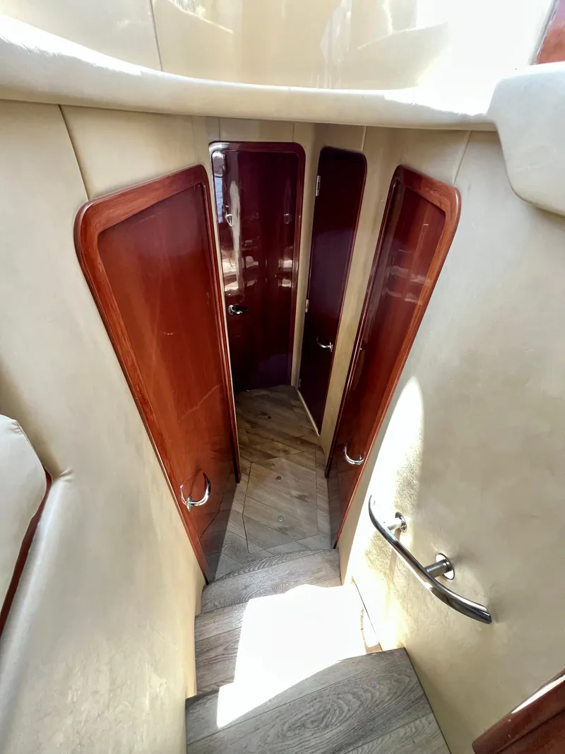 Slide: The Image of Interior view of 2002 Sea Ray 560 Sedan Bridge, featuring wooden doors and stairs. - 40