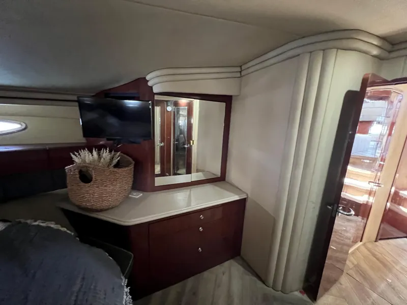 Slide: The Image of Interior of 2002 Sea Ray 560 Sedan Bridge with TV, mirror, and wicker basket. - 42