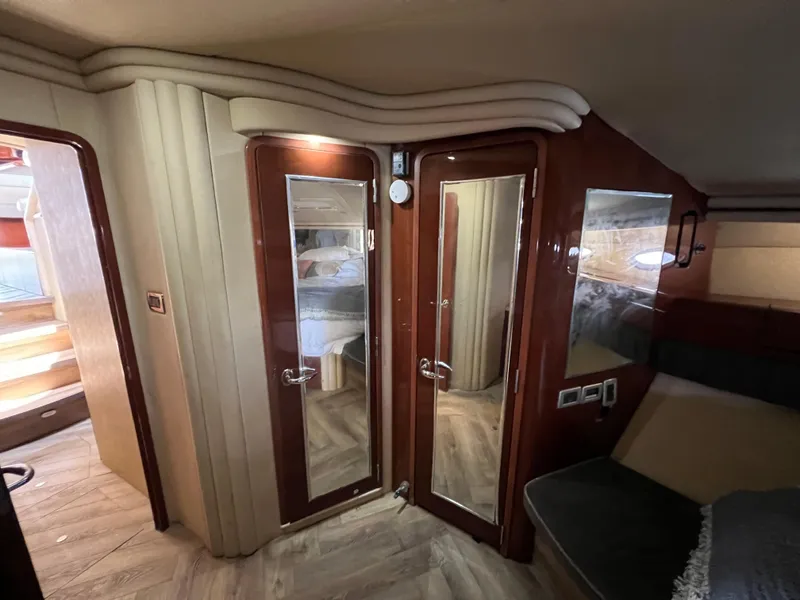 Slide: The Image of Luxurious interior of 2002 Sea Ray 560 Sedan Bridge yacht with elegant wood finishes. - 43