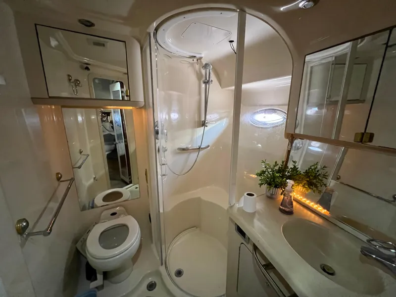 Slide: The Image of Luxurious bathroom in 2002 Sea Ray 560 Sedan Bridge yacht with shower, sink, and toilet. - 45