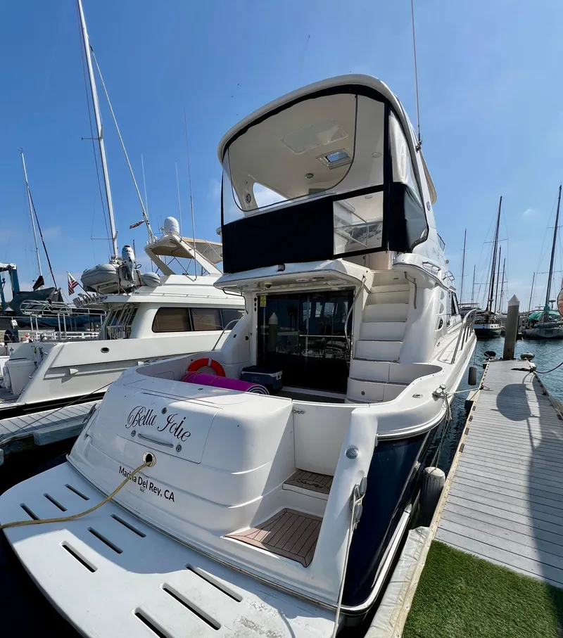 Slide: The Image of 2002 Sea Ray 560 Sedan Bridge yacht docked at marina, rear view. - 9