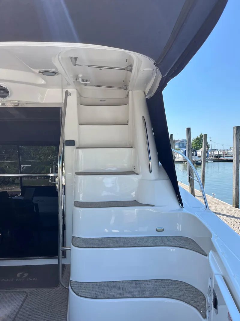Slide: The Image of Staircase on 2008 Sea Ray 58 Sedan yacht, leading to upper deck, dockside view. - 11