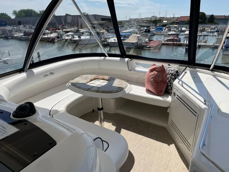 Slide: The Image of Luxurious 2008 Sea Ray 58 Sedan yacht interior with marina view, featuring plush seating and elegant table. - 15
