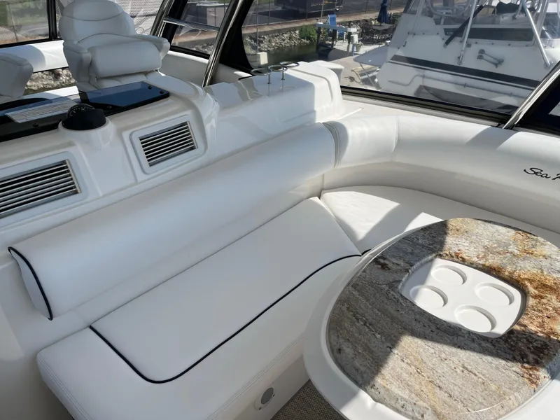 Slide: The Image of Interior of 2008 Sea Ray 58 Sedan yacht with white seating and granite table. - 16