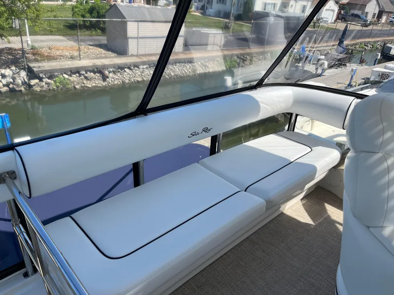 Slide: The Image of 2008 Sea Ray 58 Sedan interior with white seating and waterfront view. - 17