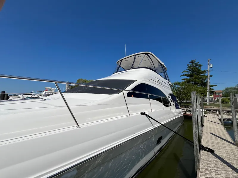 Slide: The Image of 2008 Sea Ray 58 Sedan yacht docked under clear blue sky. - 2