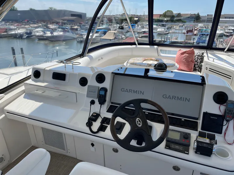 Slide: The Image of 2008 Sea Ray 58 Sedan helm with Garmin navigation, overlooking marina. - 22