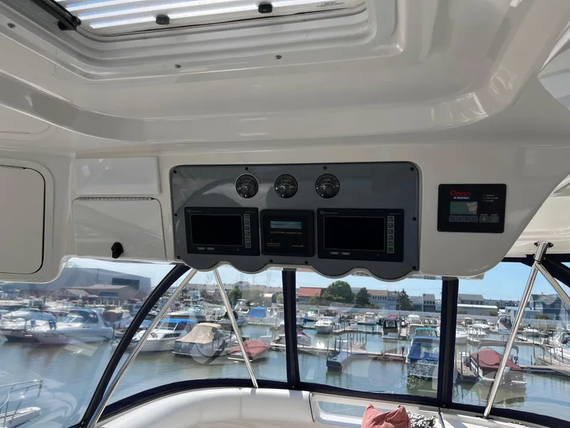 Slide: The Image of Interior view of a 2008 Sea Ray 58 Sedan yacht with control panel and marina backdrop. - 25