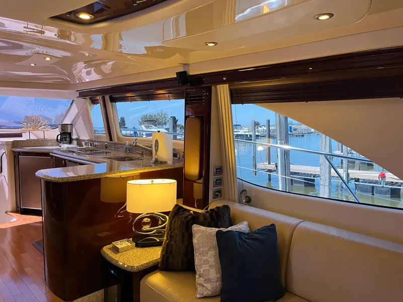 Slide: The Image of Luxurious interior of a 2008 Sea Ray 58 Sedan yacht with elegant furnishings and marina view. - 38