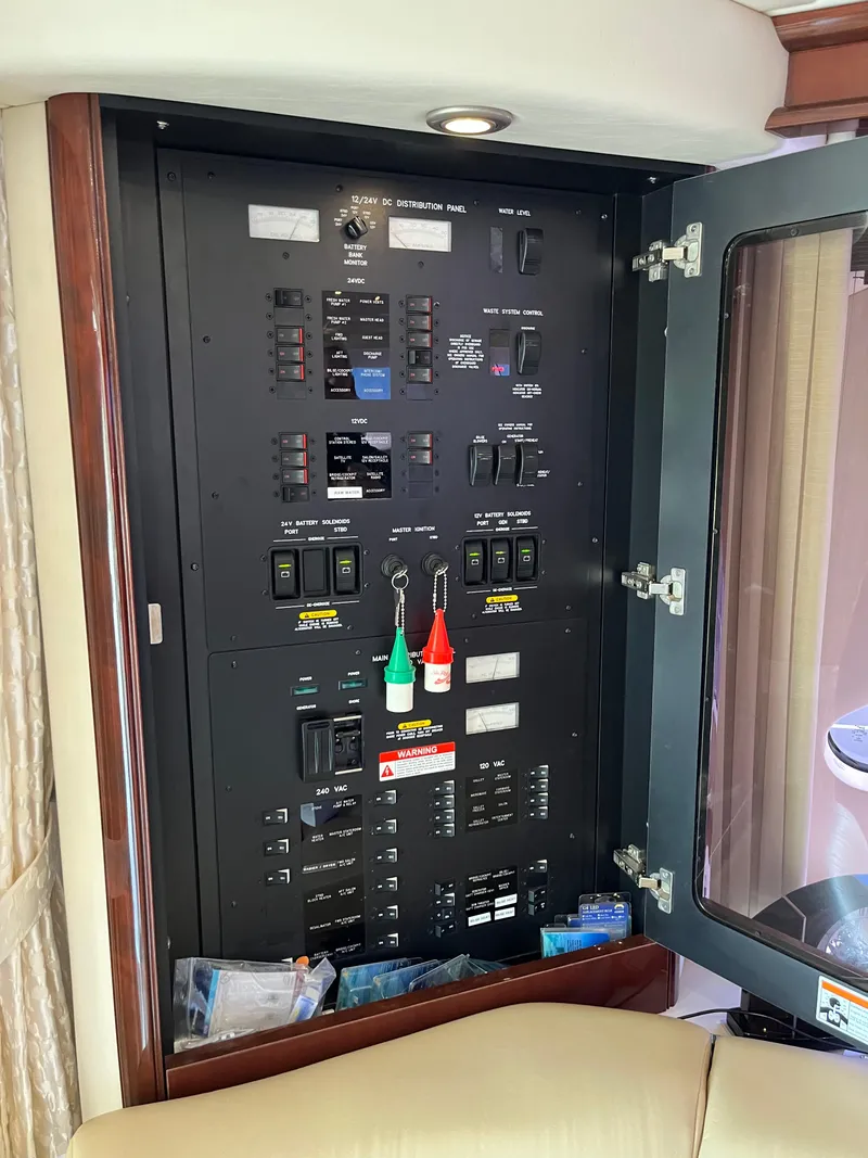 Slide: The Image of Electrical control panel inside 2008 Sea Ray 58 Sedan yacht, featuring switches and indicators. - 42