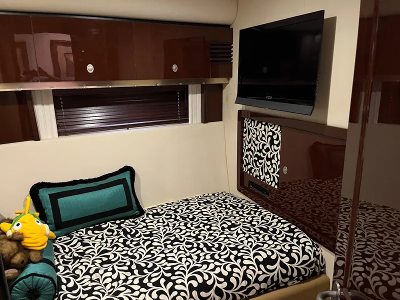 Slide: The Image of Luxurious cabin interior of 2008 Sea Ray 58 Sedan with patterned bedding and wall-mounted TV. - 47