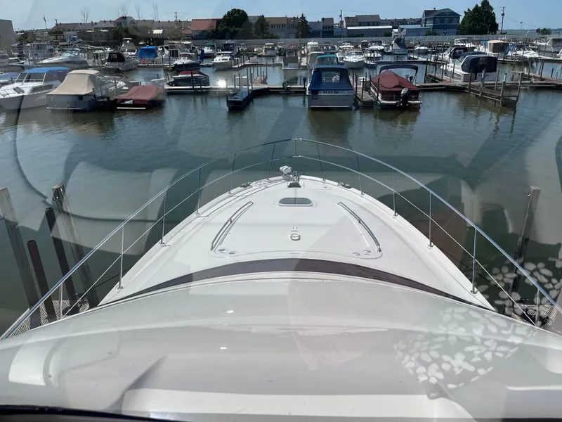 Slide: The Image of 2008 Sea Ray 58 Sedan yacht docked in a marina, surrounded by various boats. - 6