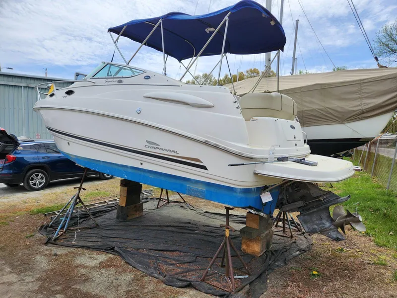 Slide: The Image of 2004 Chaparral Signature 240 boat on stands with blue canopy, in a yard setting. - 4