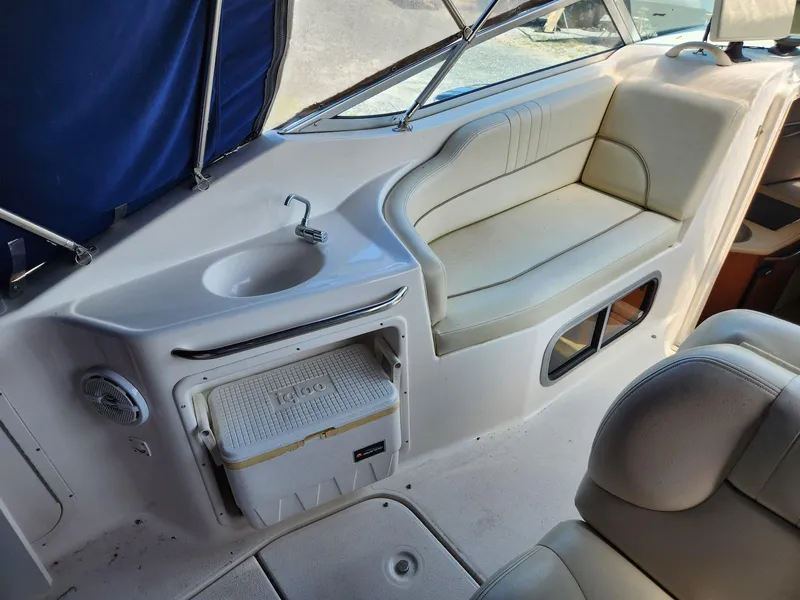 Slide: The Image of 2004 Chaparral Signature 240 boat interior with seating, sink, and cooler. - 8