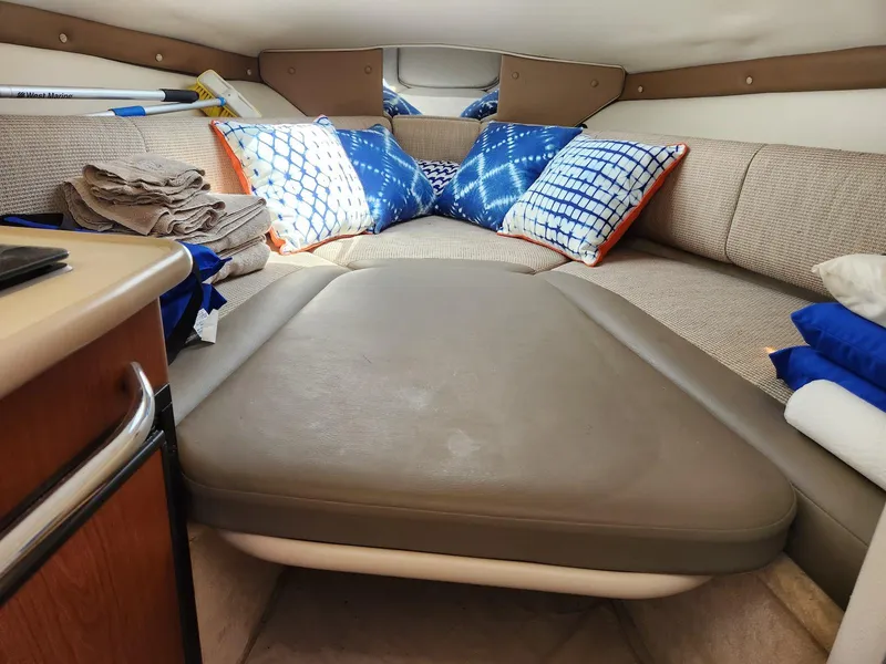Slide: The Image of 2004 Chaparral Signature 240 cabin interior with cushions and storage space. - 9