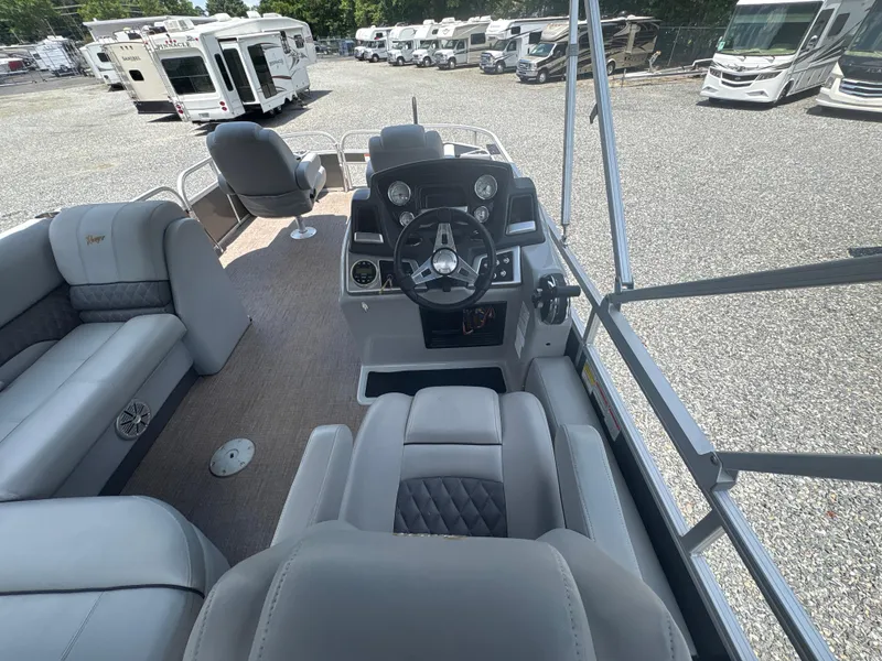 Slide: The Image of 2021 Ranger Reata 220F boat interior with steering console and seating. - 10