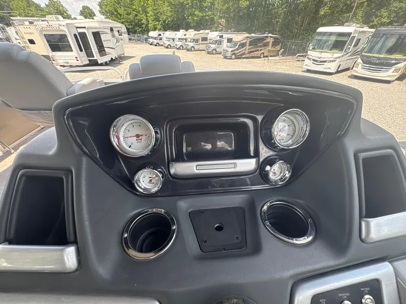 Slide: The Image of Dashboard of 2021 Ranger Reata 220F boat with gauges and cup holders. - 13