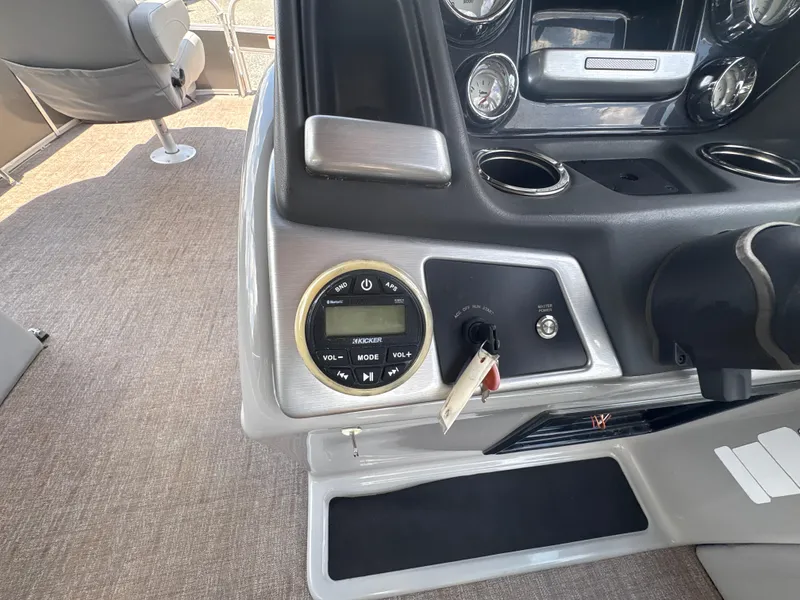 Slide: The Image of Control panel of 2021 Ranger Reata 220F boat with audio system and ignition switch. - 14