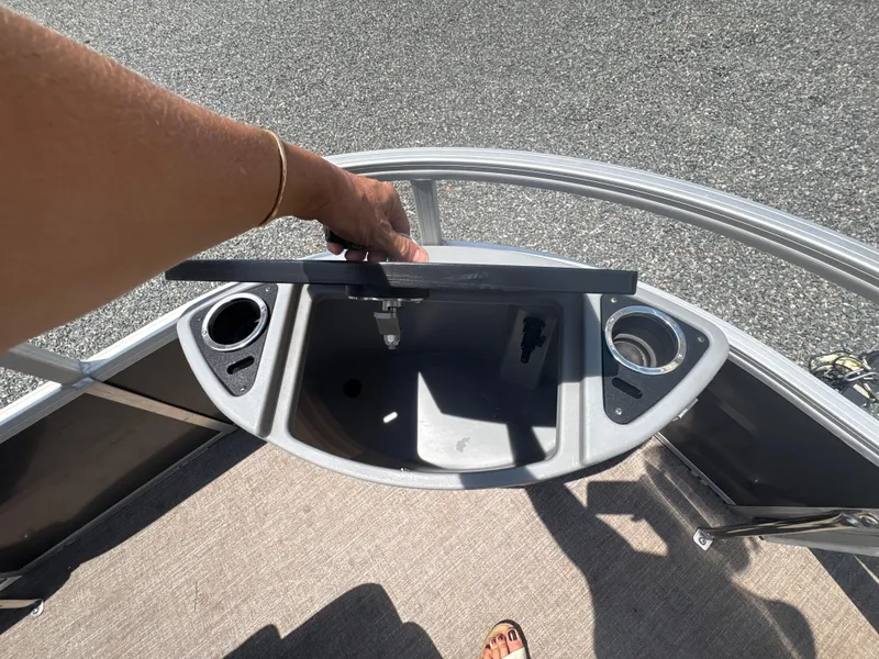 Slide: The Image of 2021 Ranger Reata 220F boat interior with storage compartment and cup holders. - 18