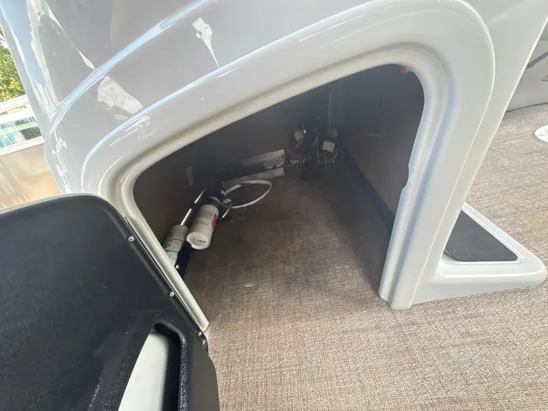 Slide: The Image of Interior storage compartment of 2021 Ranger Reata 220F boat, showing equipment and wiring. - 20