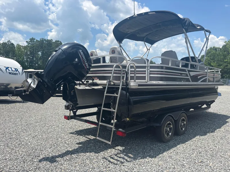 Slide: The Image of 2021 Ranger Reata 220F pontoon boat with Mercury outboard motor on a trailer. - 4