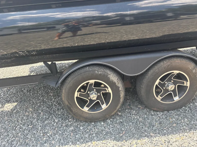 Slide: The Image of 2021 Ranger Reata 220F trailer wheels on gravel surface. - 5