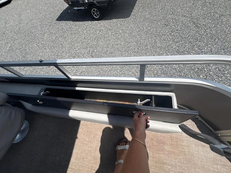 Slide: The Image of 2021 Ranger Reata 220F boat storage compartment being opened on a sunny day. - 9